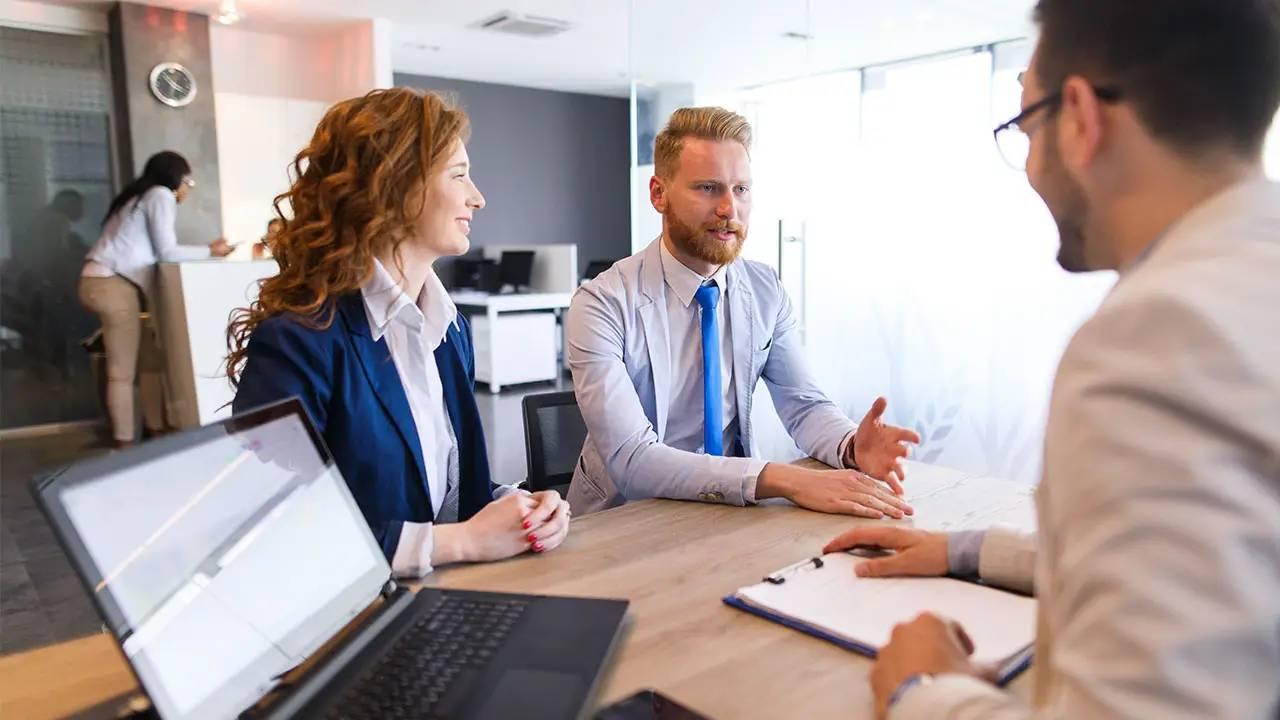 Corporate team meeting around a desk