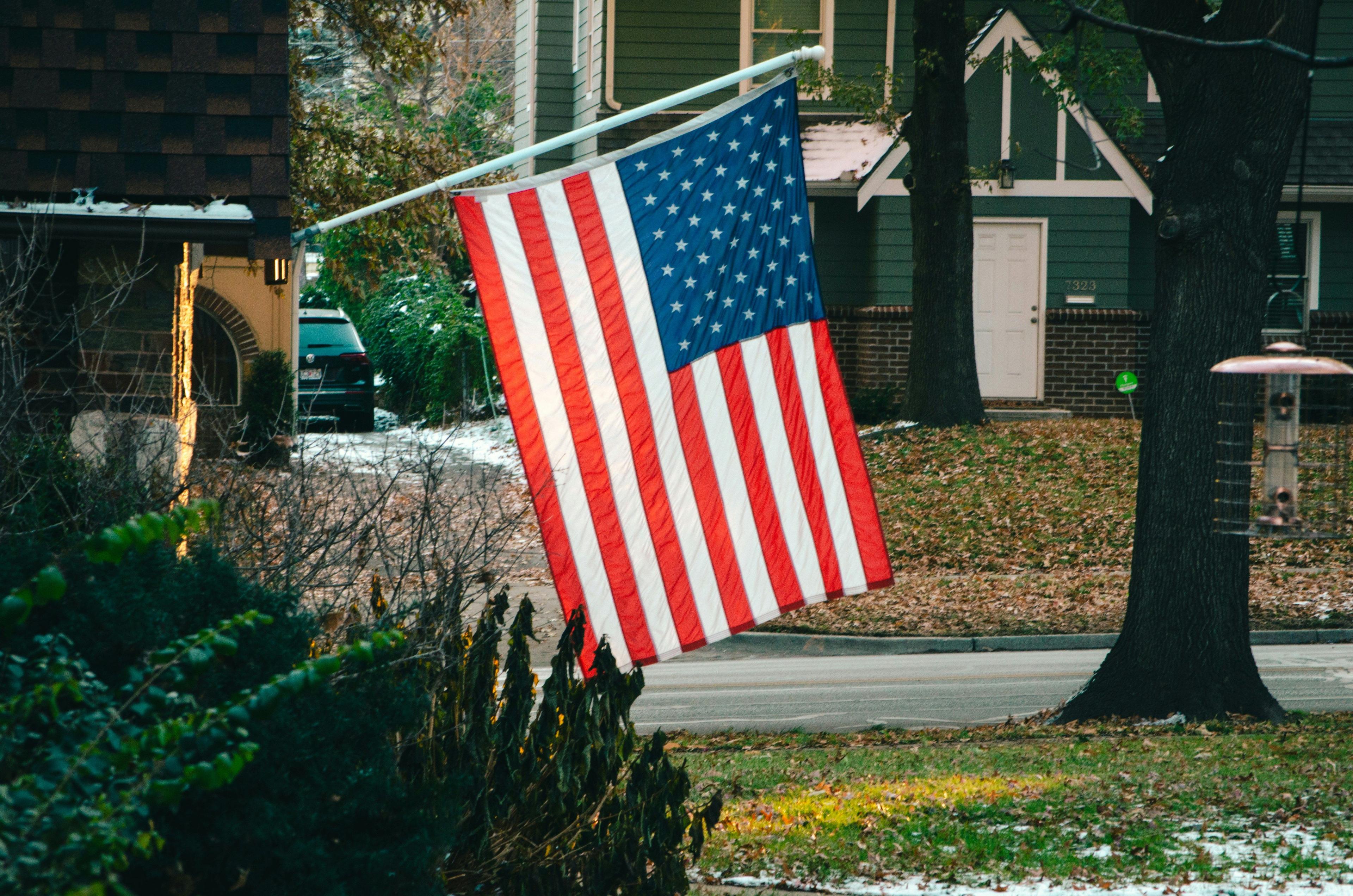 American flag hanging from house.